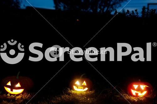 Three Jack Or Lanterns Burning In Halloween Night